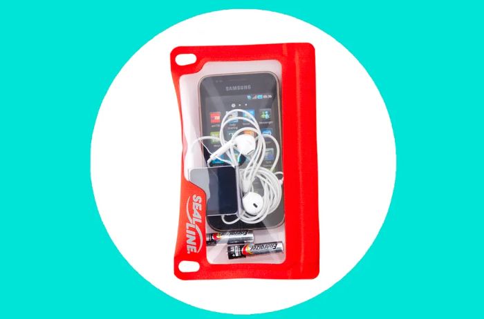 SealLine E-Case in orange, accommodating a smartphone, two small batteries, and a white cord