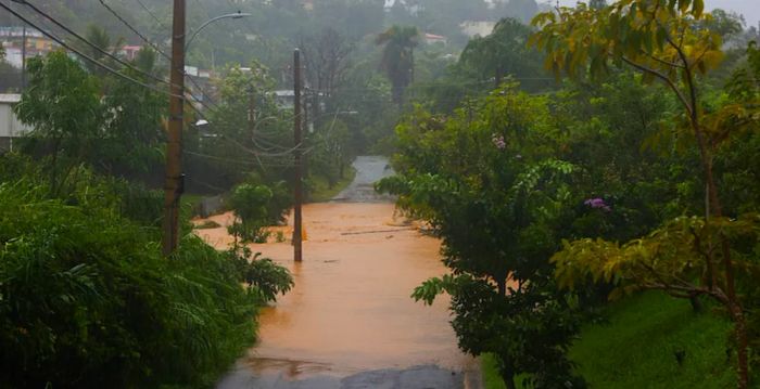 A road in Cayey, Puerto Rico, was inundated by the heavy rains of Hurricane Fiona on Sunday, Sept. 18, 2022. (AP Photo/Stephanie Rojas)