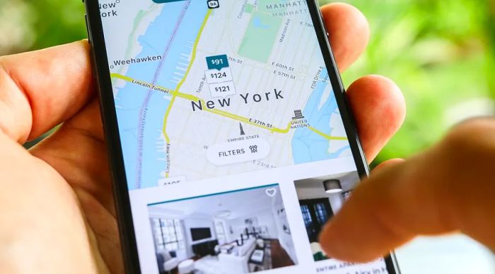 Image of the Airbnb app on a smartphone displaying a search for short-term vacation rentals in New York City