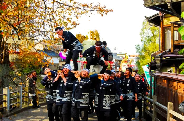 Young attendees enjoying a sake festival in the historic town of Hida Takayama, Japan, on November 14, 2010.