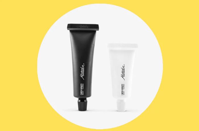 Matador Refillable Toothpaste Tubes in sleek black and white