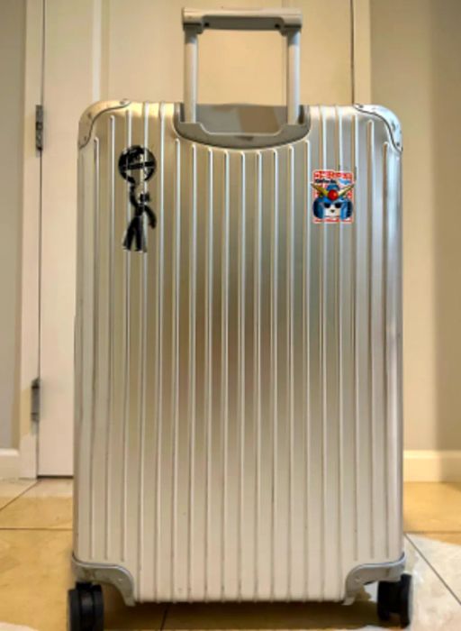 Paul Rubio's Rimowa Original Check-In Large Suitcase adorned with two stickers