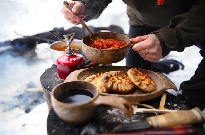 A person prepares Karelian pasties in a charming outdoor setting in Finland.