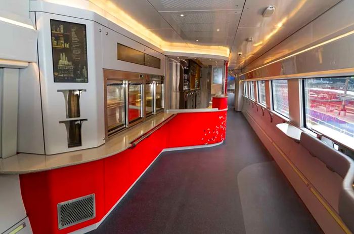 The updated café cars will offer a self-service check-out feature, a standing area with hip rests, and electrical outlets for charging devices.