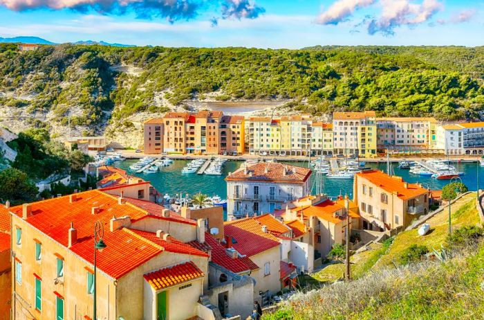 The historic town of Bonifacio, Corsica, nestled among lush green hills.