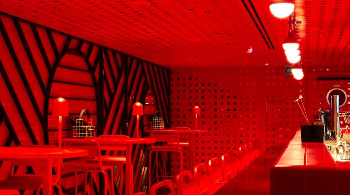 Virgin Voyages' Razzle Dazzle restaurant showcases a whimsical interior predominantly in red