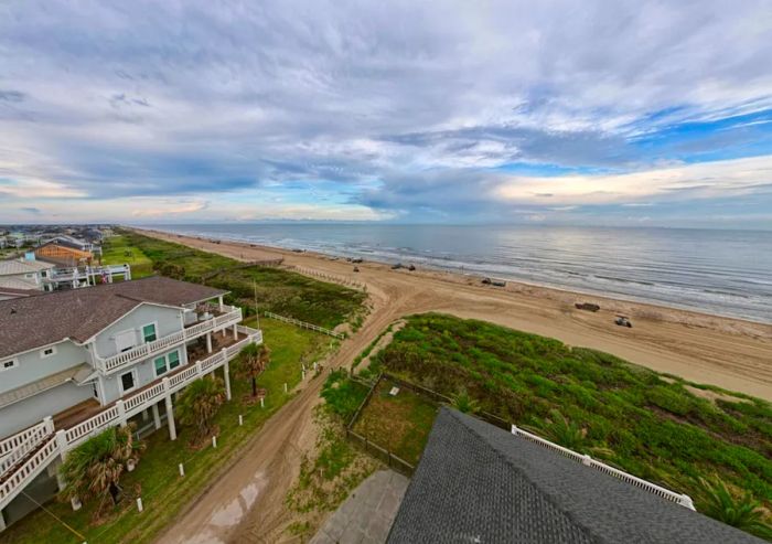 Aerial view of houses adjacent to a beach