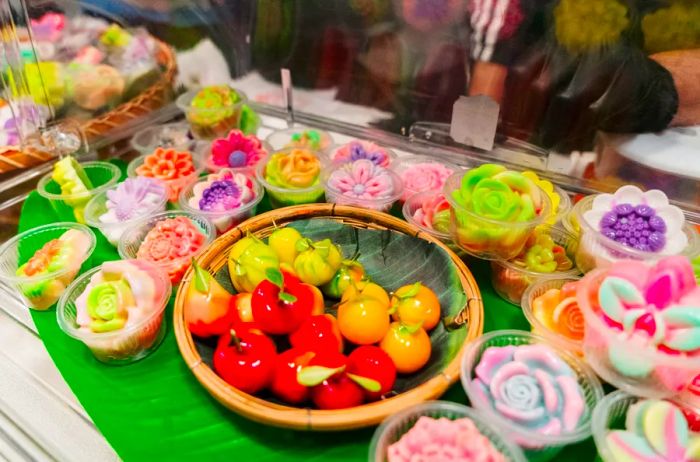 Showcase of sweets artfully crafted to resemble flowers and fruits