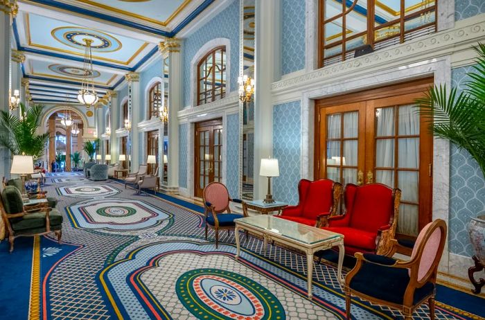 Peacock Alley at the Willard, where afternoon tea is served, boasts intricate patterned carpeting and elegant wingback chairs.