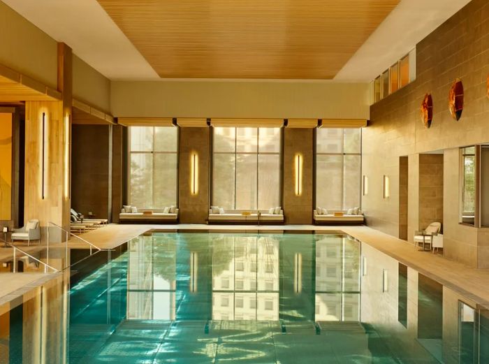 The 82-foot indoor pool at Janu Tokyo, featuring large windows on one side, invites guests to swim in natural light.