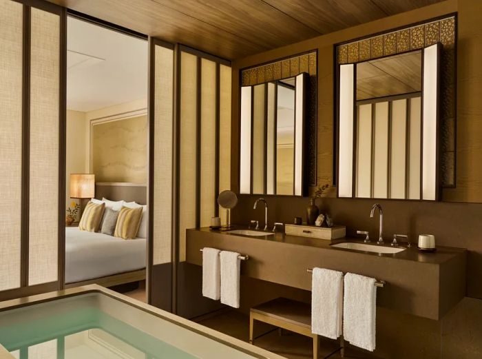 A Deluxe King Room bathroom in Janu Tokyo features a spacious soaking tub and dual sinks.