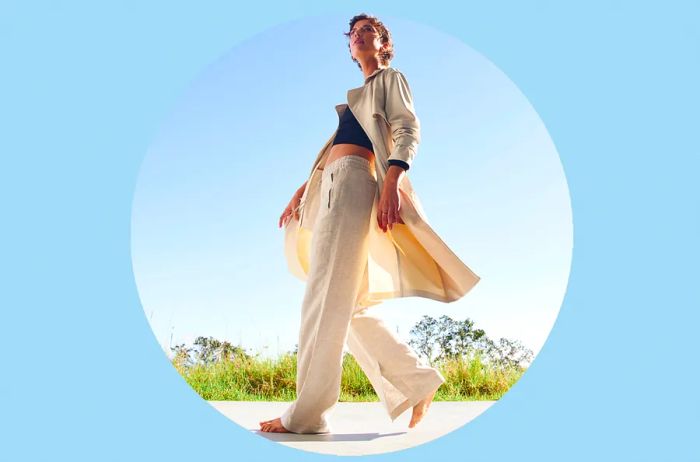 Woman sporting beige linen pants and a jacket from Athleta