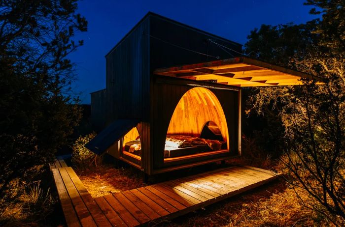 A quaint hut, illuminated from within at night