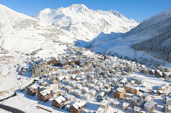 Aerial view of a snow-covered village nestled among mountains