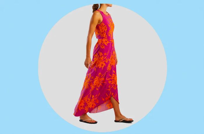 Woman in a vibrant pink and orange floral maxi dress