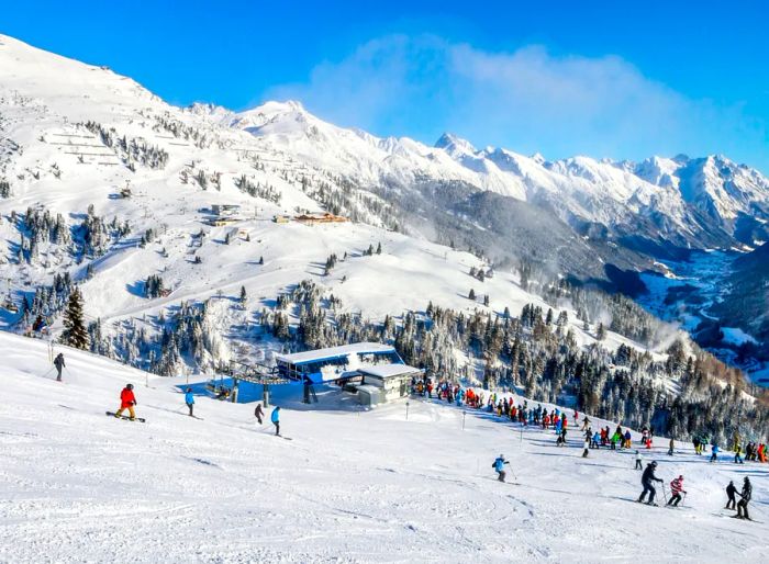 Skiers and snowboarders enjoying the slopes at the winter resort of St. Anton in Austria.