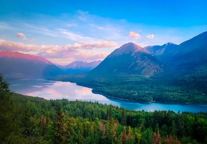 Mountains at sunset with a river flowing in the foreground