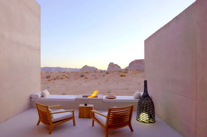 The patio at Amangiri hotel features two chairs and a firepit, offering breathtaking views of the Utah desert.