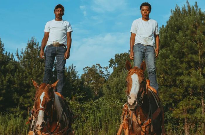 Two individuals mounted on horses