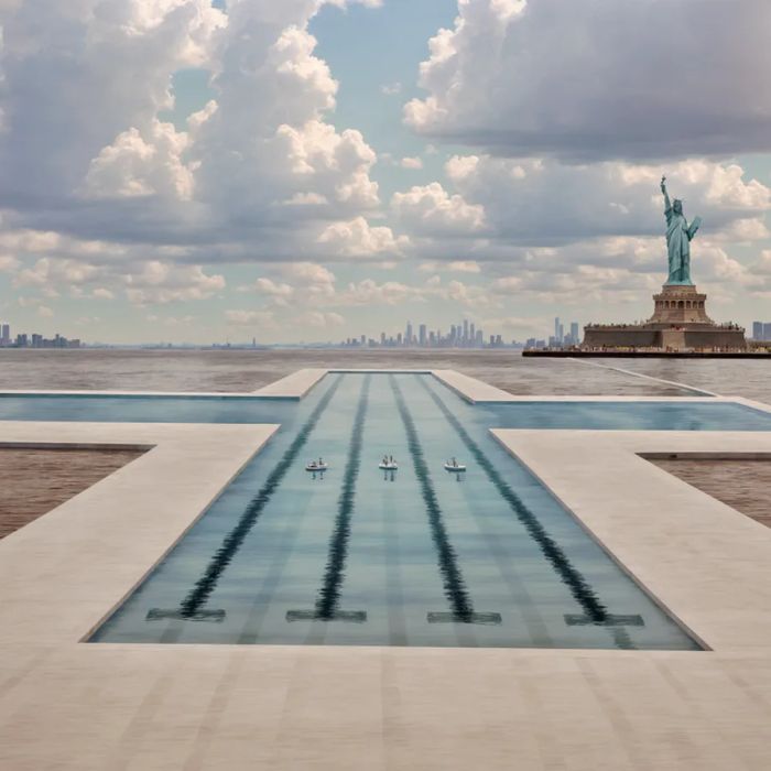 A cross-shaped pool with the iconic Statue of Liberty in view