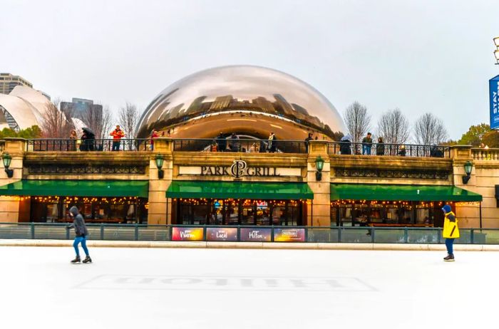 People are enjoying ice skating on a rink in downtown Chicago.