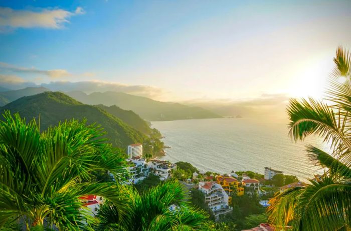 Aerial view of coastal buildings framed by mountains in the background