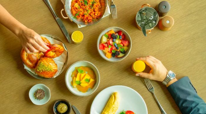 Aerial view of a table for two at Arrazuna restaurant, adorned with small bowls of vibrant dishes.