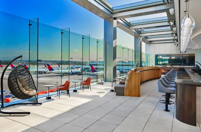 Enjoy a drink outdoors while watching planes take off and land at the newly opened Delta Sky Club.