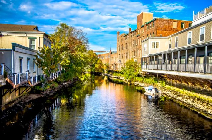 A river bordered by historic buildings in Westerly, Rhode Island.