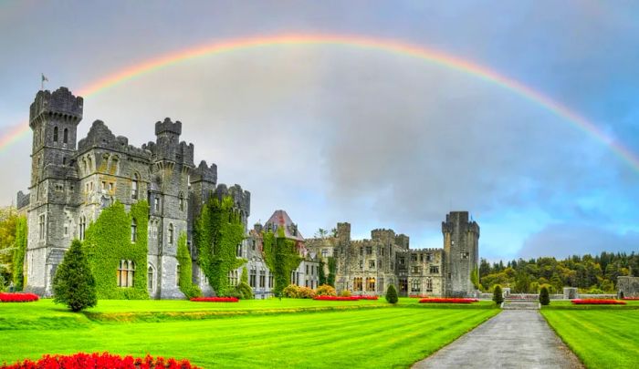 A vibrant rainbow arcs over a castle.