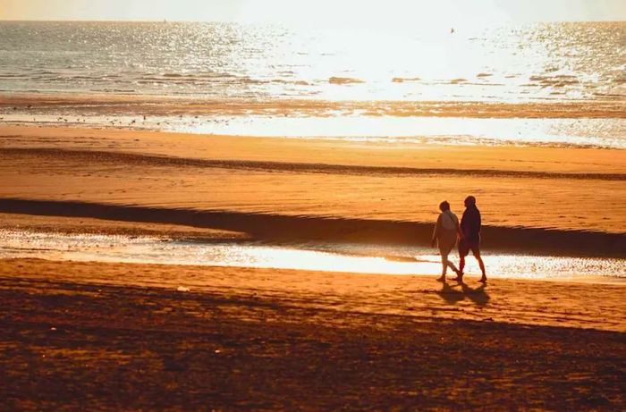 couple strolling along the shoreline