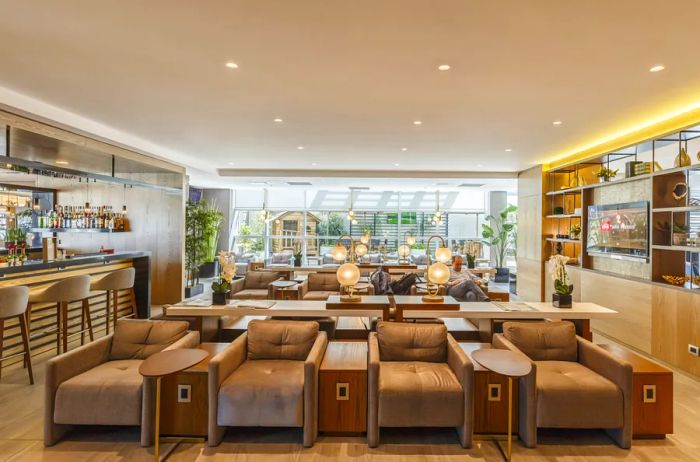 The tan bar and seating area at the Sala VIP Internacional in Quito International Airport, Ecuador.