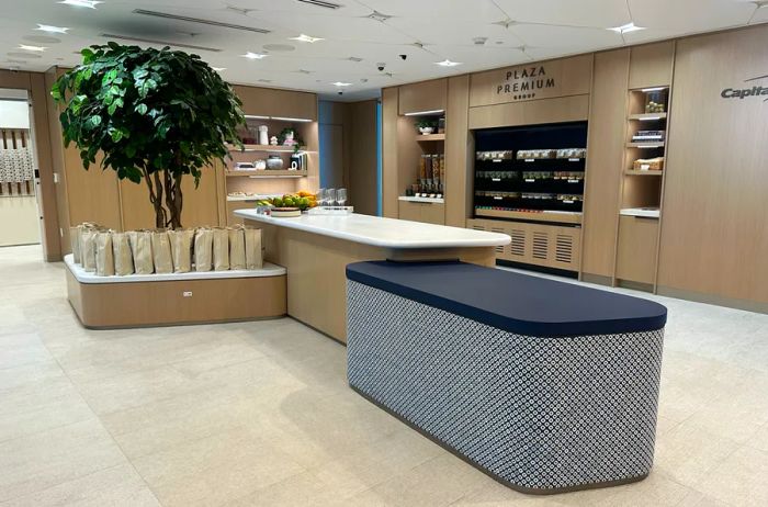 The beige reception area of the Capital One Lounge, currently empty of guests.