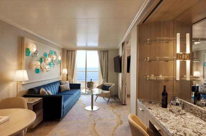 Image showcasing a suite on the Crystal Symphony featuring a sofa, a marble bar area, and a balcony.