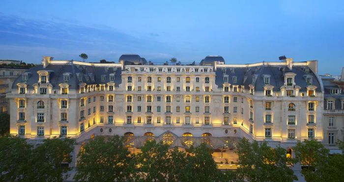 The exterior of the Peninsula Paris showcases a grand Hausmannian structure from the early 19th century.