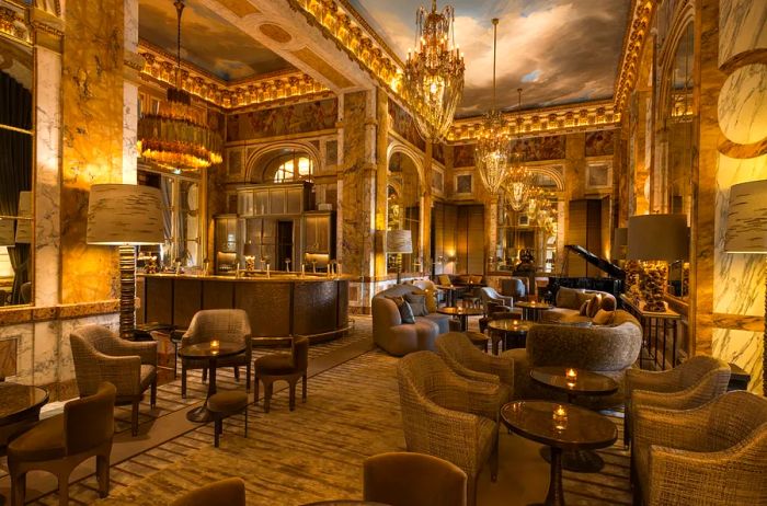 The elegantly gold-accented Bar Les Ambassadeurs in Paris.