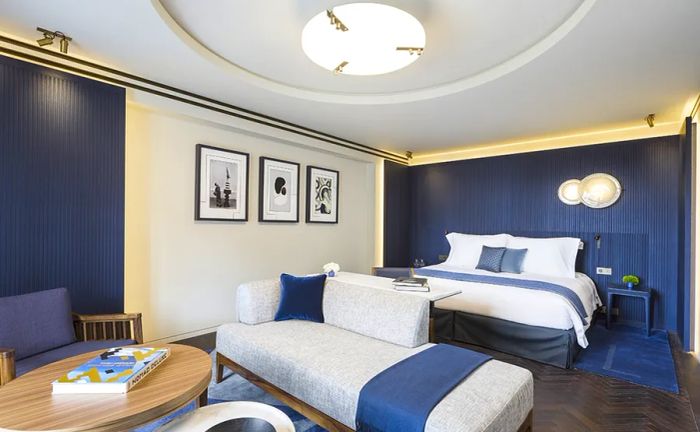 Interior view of a blue and white guest room at Hôtel Lutetia Paris