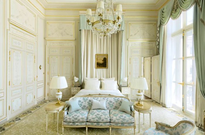 Interior of the elegant white Windsor Suite at the Ritz Paris.