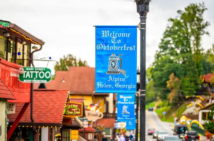 Close-up of a blue Bavarian banner on a lamppost for Oktoberfest in Helen, adorning the street lined with shops.