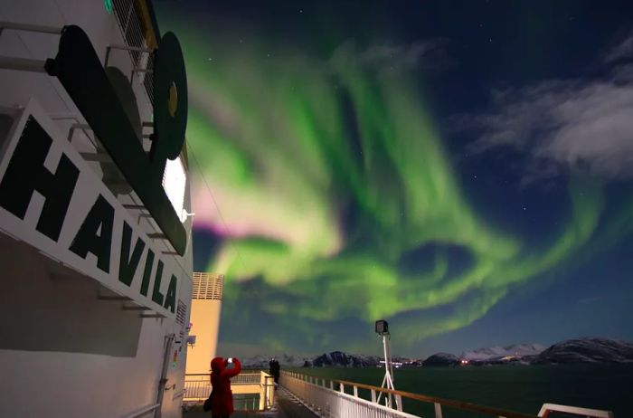 The Northern Lights seen from the deck of a Havila Voyages ship