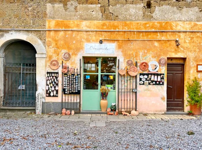 A vibrant ceramic shop front against a sunny yellow wall.