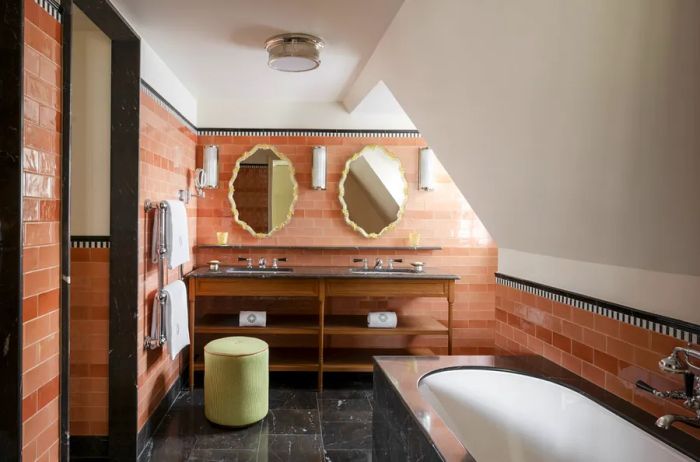 The bathroom at Le Grand Mazarin boasts a spacious soaking tub and beautifully tiled walls.