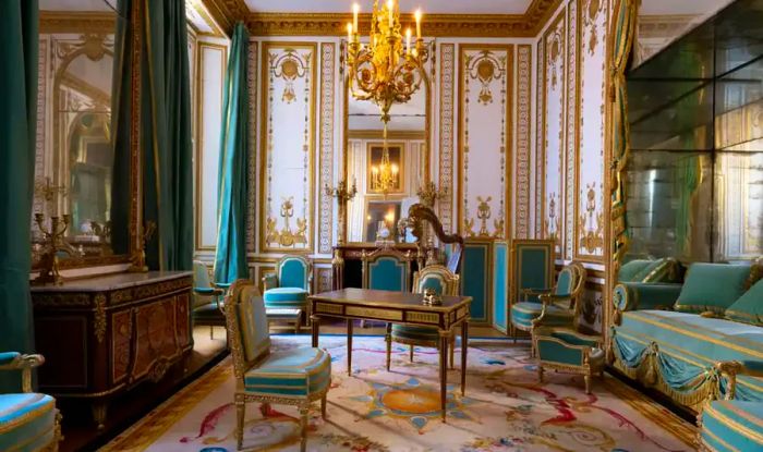 Interior view of one of Marie Antoinette's rooms featuring teal upholstery and curtains.