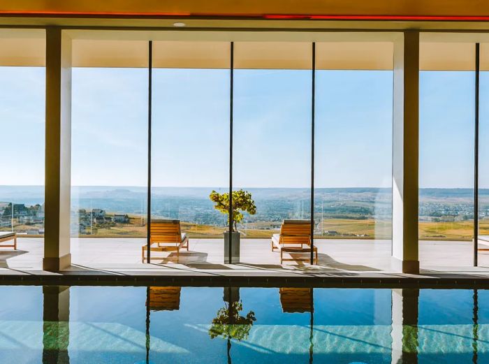 The indoor pool at the Royal Champagne in France boasts sweeping views of the countryside.