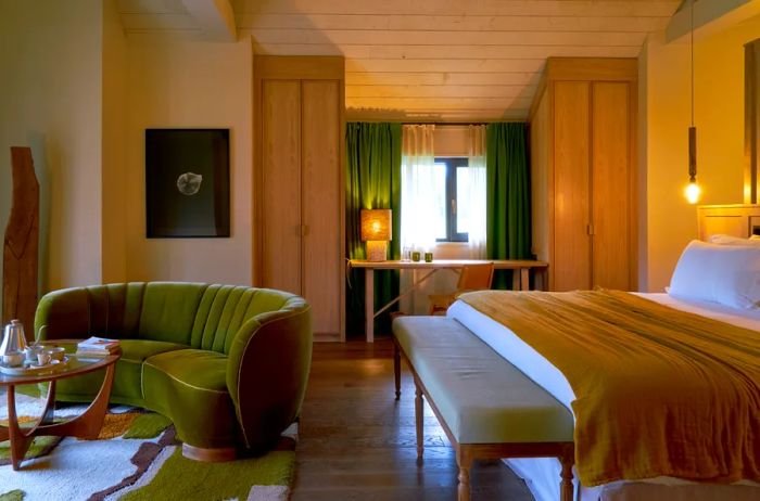 Interior of guest room at Les Sources de Cheverny, featuring a curved green sofa.