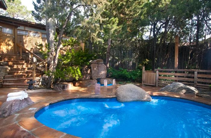 A tranquil pool surrounded by trees at the Ten Thousand Waves hotel in Santa Fe, New Mexico.