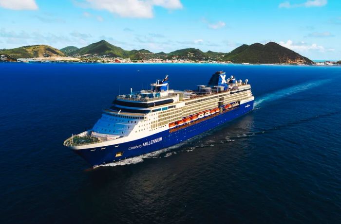 The Celebrity Millennium cruise ship navigating waters, with lush green hills in the background