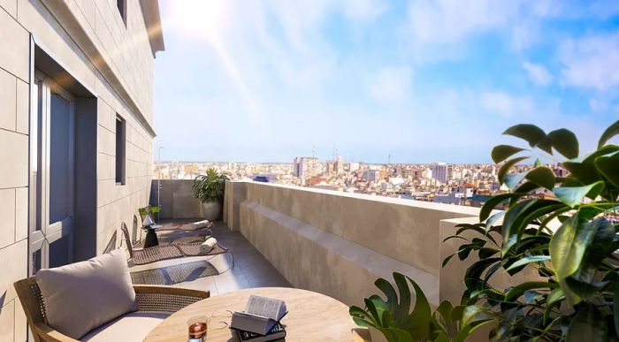 A hotel room balcony with a view of Buenos Aires, featuring tan furniture and a tan balcony wall.