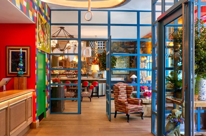 The lobby is a vibrant space, adorned with walls and fixtures in shades of red, green, and bright blue.