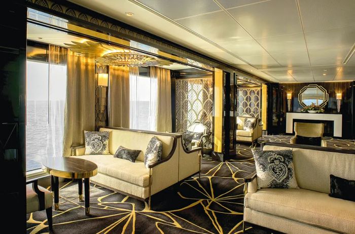 An elegant lounge featuring cream-colored sofas and art deco styling aboard Regent Seven Seas' 